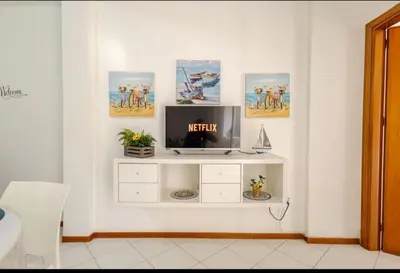 a living room with a tv on a white wall at Stella a 3 minuti dal mare e a 30 Min from San Vito in Alcamo Marina