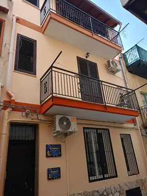 an apartment building with a balcony and a fan at Fabian Appartament in Bagheria