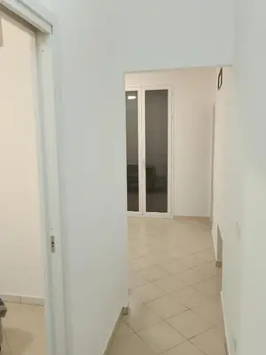 an empty hallway with white walls and tile floors at Fabian Appartament in Bagheria