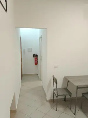 a dining room with a table and chairs and a fire hydrant at Fabian Appartament in Bagheria