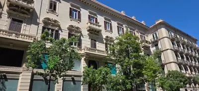 a large building with trees in front of it at Dimora Blu in Palermo