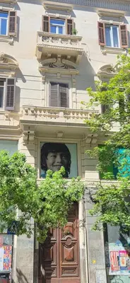 a face in a window above a door at Dimora Blu in Palermo
