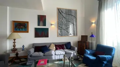 a living room with a couch and two chairs at Dimora Blu in Palermo
