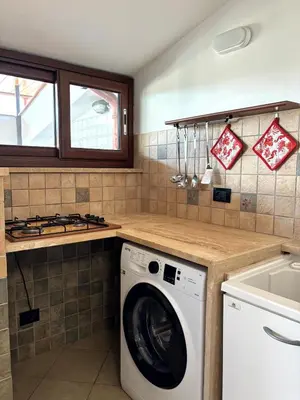 a kitchen with a washing machine and a sink at casa 3 nodi in Carini