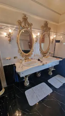 a bathroom with two sinks and two mirrors at Casa mogia in Palermo