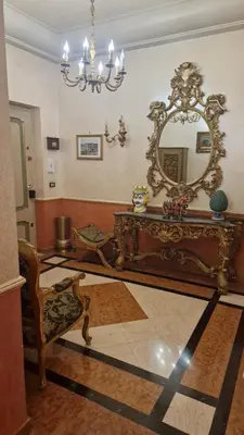 a room with a mirror and a table and a chair at Casa mogia in Palermo