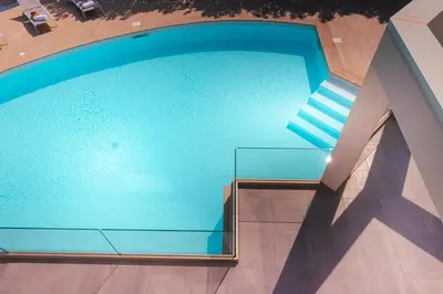 an overhead view of a swimming pool in a building at Gelso Bianco Collection Apartments in Campofelice di Roccella