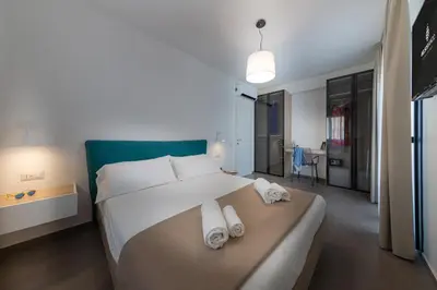 a bedroom with a large bed with towels on it at Gelso Bianco Collection Apartments in Campofelice di Roccella
