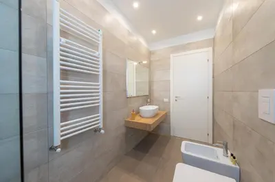 a bathroom with a toilet and a sink and a mirror at Gelso Bianco Collection Apartments in Campofelice di Roccella