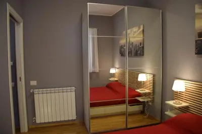 a room with a glass partition with a red bed at New Palermo Holidays Penelope in Mondello