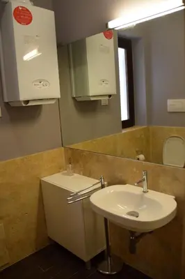 a bathroom with a sink and a mirror at New Palermo Holidays Penelope in Mondello