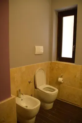a bathroom with a toilet and a sink at New Palermo Holidays Penelope in Mondello