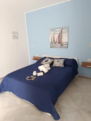 a blue bed with two stuffed animals on it at AmarMare Bed&Breakfast in Trappeto