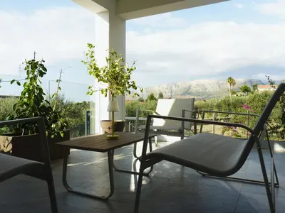 a table and chairs on a patio with a view at AmarMare Bed&Breakfast in Trappeto