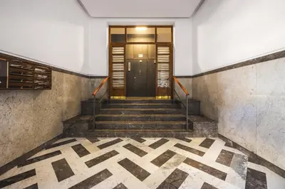 a hallway with stairs leading to a door at Giada's House By DomuSicily in Palermo