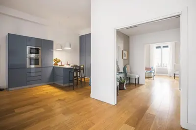 a kitchen and living room with blue cabinets at Giada's House By DomuSicily in Palermo