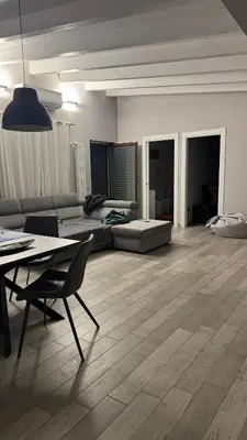 a living room with a table and a couch at Brezza Marina apartment in Carini