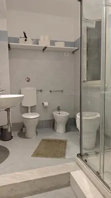 a bathroom with a toilet and a sink and a shower at Profumo di casa 2 in Lascari