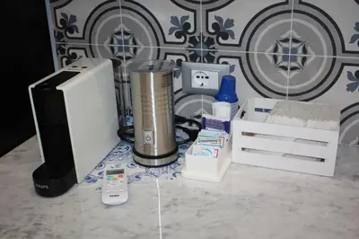 a desk with a computer and other items on it at Sapphire Home in Palermo