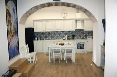 a kitchen with a white table and chairs at Sapphire Home in Palermo