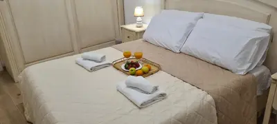 a bed with a tray of fruit on it at Sapphire Home in Palermo