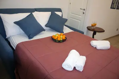 a bed with towels and a bowl of fruit on it at Sapphire Home in Palermo