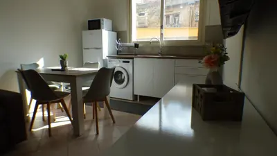 a kitchen with a table and chairs and a kitchen with a sink at Apollo Apartment in Palermo
