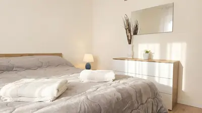 a bedroom with a bed with two pillows on it at Apollo Apartment in Palermo
