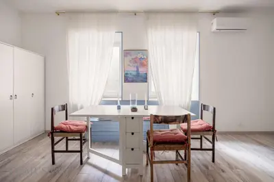 a dining room with a table and two chairs at Loggiato dei Ventimiglia By DomuSicily in Palermo