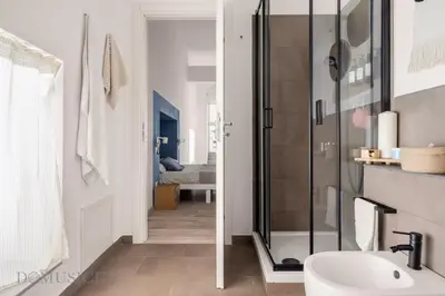 a bathroom with a glass shower and a sink at Loggiato dei Ventimiglia By DomuSicily in Palermo