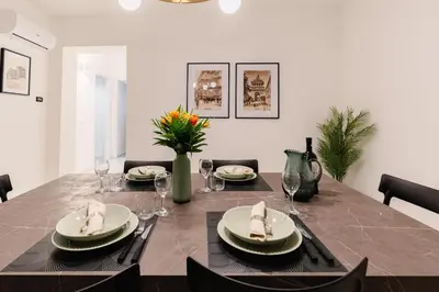 a dining room with a table with plates and napkins at Dimora d'incanto al Capo in Palermo