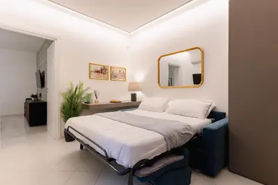 a bedroom with a large bed and a mirror at Dimora d'incanto al Capo in Palermo