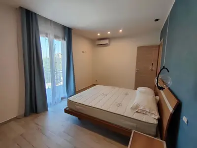 a bedroom with a bed and a large window at Brezza Marina in Alcamo