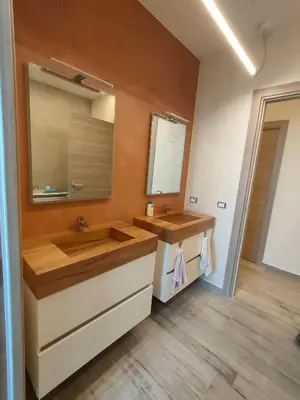 a bathroom with a sink and a large mirror at Brezza Marina in Alcamo