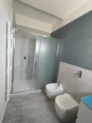 a bathroom with a shower and a toilet and a sink at Brezza Marina in Alcamo