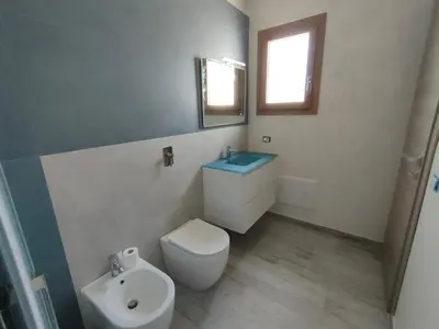 a bathroom with a toilet and a sink at Brezza Marina in Alcamo