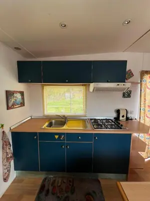 a kitchen with blue cabinets and a sink at Casa Allegra in Termini Imerese