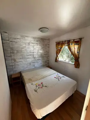 a bedroom with a bed and a brick wall at Casa Allegra in Termini Imerese
