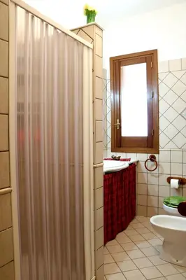 a bathroom with a shower and a toilet and a sink at Villetta Gelsomini, San Vito Lo Capo in San Vito lo Capo