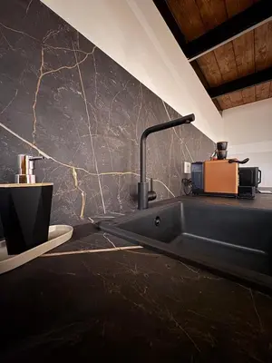 a coffee maker with a cup on top of it at The Suite Castellammare del Golfo in Castellammare del Golfo