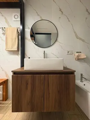 a bathroom with a sink and a mirror at The Suite Castellammare del Golfo in Castellammare del Golfo