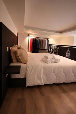 a bedroom with a bed with two towels on it at The Suite Castellammare del Golfo in Castellammare del Golfo