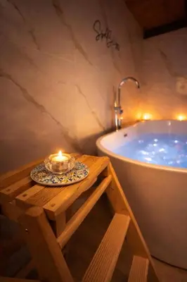 a bathroom with a shower with a light on the wall at The Suite Castellammare del Golfo in Castellammare del Golfo