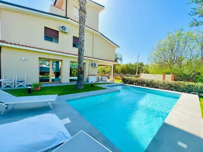 a swimming pool in front of a house at Villa Donna Vincenza