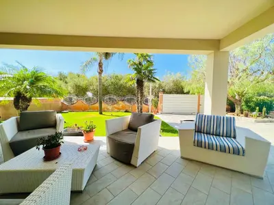 a patio with couches and a table and chairs at Villa Donna Vincenza