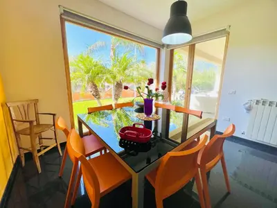 a dining room with a table and chairs and a window at Villa Donna Vincenza