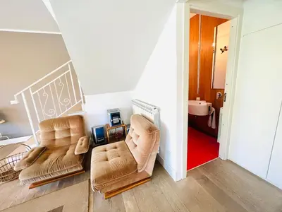 two chairs in a living room with a red rug at Villa Donna Vincenza