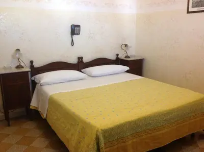 two beds sitting next to each other in a room at Albergo Cavour in Palermo