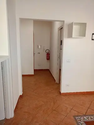 an empty room with a hallway with a fire extinguisher at Fabian Appartament in Bagheria