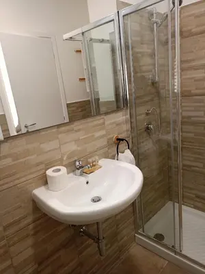 a bathroom with a sink and a shower at Fabian Appartament in Bagheria